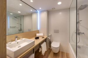 a bathroom with a sink and a toilet and a shower at Don Gregory by Dunas - Adults Only in San Agustin
