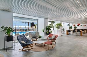 a lobby with chairs and a table and a pool at Don Gregory by Dunas - Adults Only in San Agustin