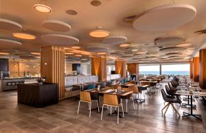 a restaurant with tables and chairs and a bar at Don Gregory by Dunas - Adults Only in San Agustin