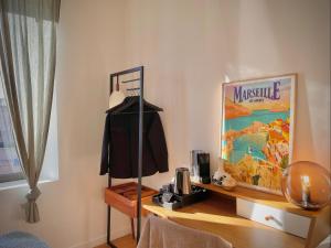 a room with a table with a mannequin on a shelf at Maï Homes - La Villa Bompard in Marseille