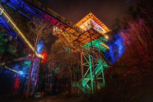 a roller coaster at night with colorful lights at FeWo Robin in Bad Harzburg