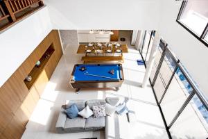 an overhead view of a living room with a pool table at Bangkok Luxury Pool Villa Thonglor in Ban Na Song