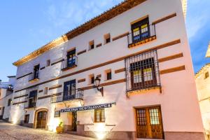 a large white building with a sign that reads theoren neighbourhood at YIT Abentofail in Guadix