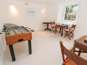 a living room with a foosball table and chairs at Scillonia in Penzance