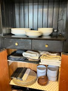 a cabinet with plates and bowls on top of it at Gorlero Benwi 117 in Punta del Este