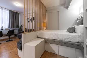 a bedroom with a bed and a desk at Athens Gateaway Next To Kallimarmaro And Acropolis in Athens
