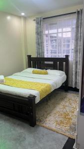 Uma cama ou camas num quarto em Naka Executive Suites.