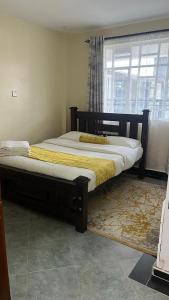Uma cama ou camas num quarto em Naka Executive Suites.