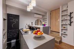 a kitchen with a bowl of fruit on a counter at Athens Gateaway Next To Kallimarmaro And Acropolis in Athens