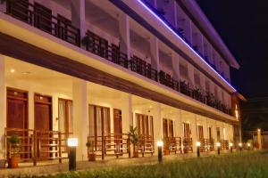 a building with a balcony with lights on it at Hotel Havelock Gateway in Havelock Island