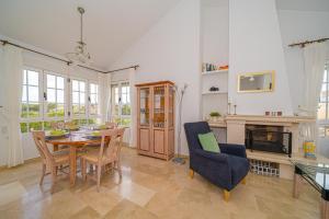 a dining room with a table and chairs and a fireplace at Casa Pia in Orihuela Costa