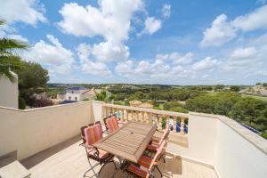 a deck with a table and chairs on a balcony at Casa Pia in Orihuela Costa