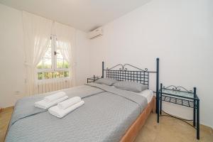 a bedroom with a bed with two towels on it at Casa Pia in Orihuela Costa +18 photos