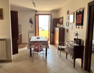 a kitchen with a table and a table and chairs at Casa Corinaldesi in Marotta