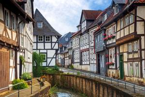 a street in a town with houses and a canal at FeWo Sonnenschein mit Whirlpoolbadewanne in Bad Harzburg