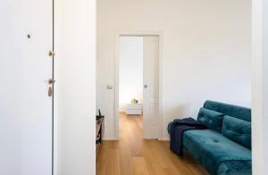 sala de estar con sofá azul y espejo en Milano Affori - Stile e comfort, en Milán