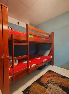 two bunk beds in a room with a rug at Qamar home rental Deira in Dubai