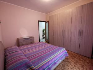 a bedroom with a large bed and wooden cabinets at Principessa in Nizza Monferrato