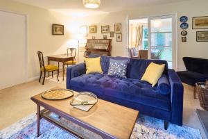 a living room with a blue couch and a table at Host & Stay - Mayfield in Blean
