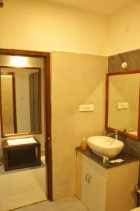 a bathroom with a sink and a mirror at Hotel Havelock Gateway in Havelock Island