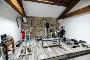 a gym with several treadmills and exercise equipment at Chambres d hôtes du Castell de Blés in Saint-Génis