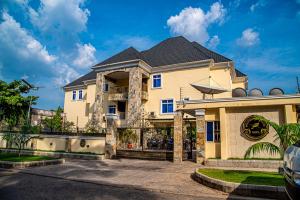 a house with a gate in front of it at Fritz Apartments & Suites in Abuja