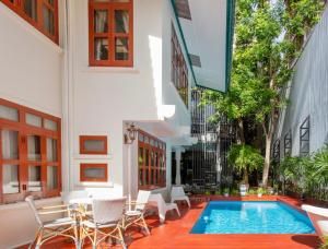 a courtyard with a swimming pool in a building at Sathorn Private Pool Villa in Bangkok