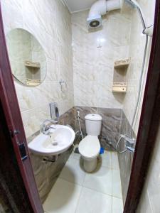 a bathroom with a toilet and a sink at Oscar pyramids view in Cairo