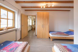 a bedroom with two beds and a cabinet in it at Schelterhof in Wunsiedel