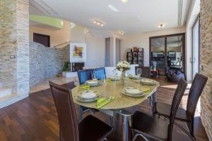 a dining room and living room with a table and chairs at Holiday Home Villa Lion's House in Crikvenica