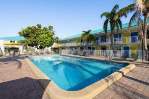 a swimming pool in front of a hotel at Days Inn by Wyndham Fort Pierce Midtown in Fort Pierce