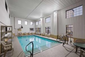 a large swimming pool in a large room with at Days Inn by Wyndham Oklahoma City in Oklahoma City