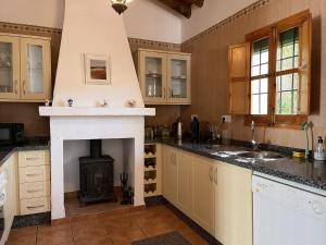 a kitchen with a fireplace and a stove at Casa Jasmin 