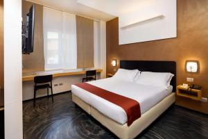 a hotel room with a bed and two chairs at Best Western Hotel Major in Milan