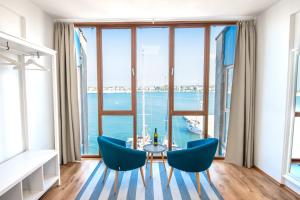 a room with a table and chairs and a large window at Umag center seafront seaview old town apartment rentistra 1 in Umag