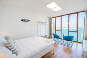 a bedroom with a bed and a table and chairs at Umag center seafront seaview old town apartment rentistra 1 in Umag