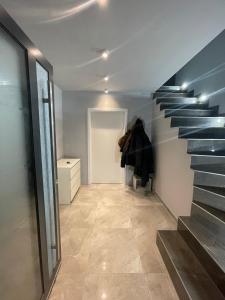 a hallway with a staircase with blue steps at Cozy Apartment near Vienna Airport in Schwechat