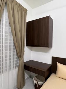 a bedroom with a bed with a cabinet and a curtain at 162 RESIDENCY SELAYANG in Batu Caves