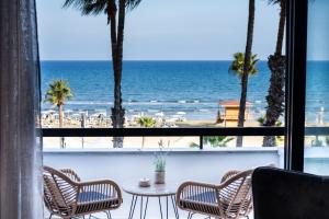 a view of the beach from a hotel room at Quattro Beachfront Sea View Ap 206 in Larnaka