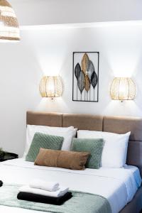 a bedroom with a bed with green and white pillows at Quattro Beachfront Sea View Ap 206 in Larnaka