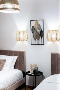 a bedroom with two beds and two lamps on the wall at Quattro Beachfront Sea View Ap 206 in Larnaka