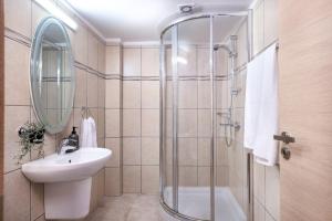 a bathroom with a sink and a shower at Quattro Beachfront Sea View Ap 206 in Larnaka