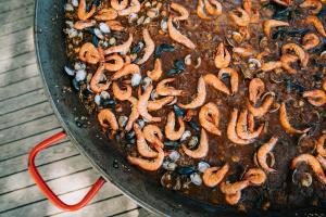 a pan full of food on a table at Tamarit Beach Resort in Tamarit