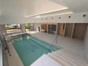 a swimming pool in a building with some stairs at Tamarit Beach Resort in Tamarit