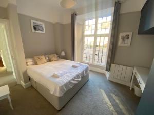 a small bedroom with a bed and a window at Crowcombe Court in Crowcombe