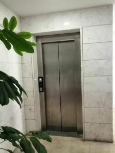 a metal elevator door in a building at Quattro Beachfront Sea View Ap 206 in Larnaka