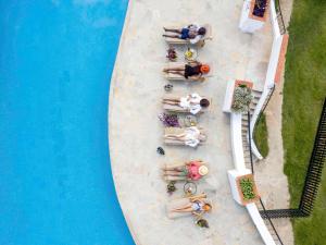 an overhead view of a pool with people laying around it at Fairmont Mount Kenya Safari Club in Nanyuki