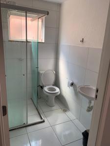a bathroom with a shower and a toilet and a sink at Aconchego in Petrolina