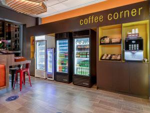 a coffee corner in a restaurant with two refrigerators at ibis budget Lima Miraflores in Lima