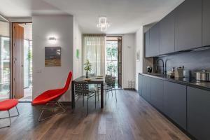 a kitchen and dining room with a table and chairs at Luxury apartment - Free Parking - Duomo-Navigli in Milan